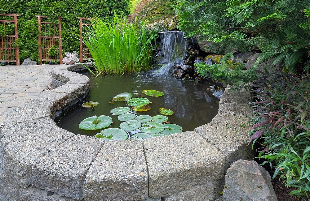 Small pond surrounded by block wall