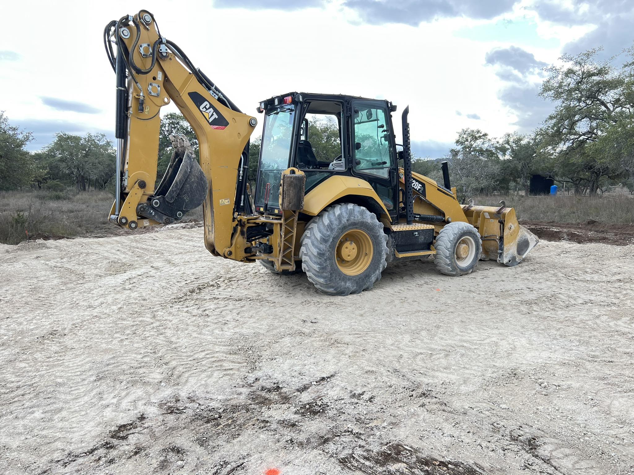 backhoe sitting on a graded lot backhoe sitting on a graded lot