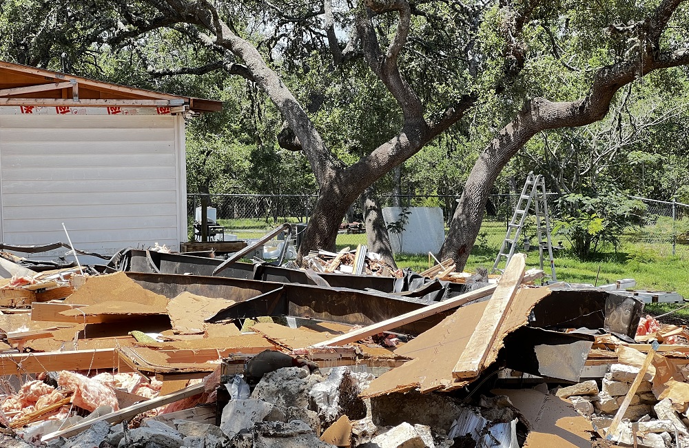 demolition of a home with yard waste still on the ground demolition of a home with yard waste still on the ground