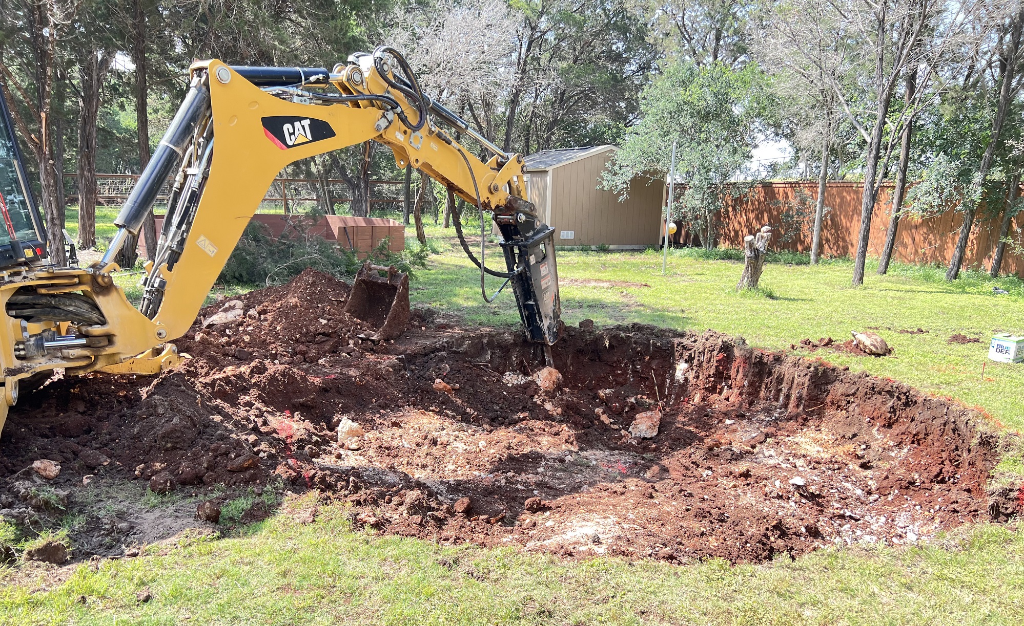 backhoe digging a hole for a recessed trampoline site backhoe digging a hole for a recessed trampoline site