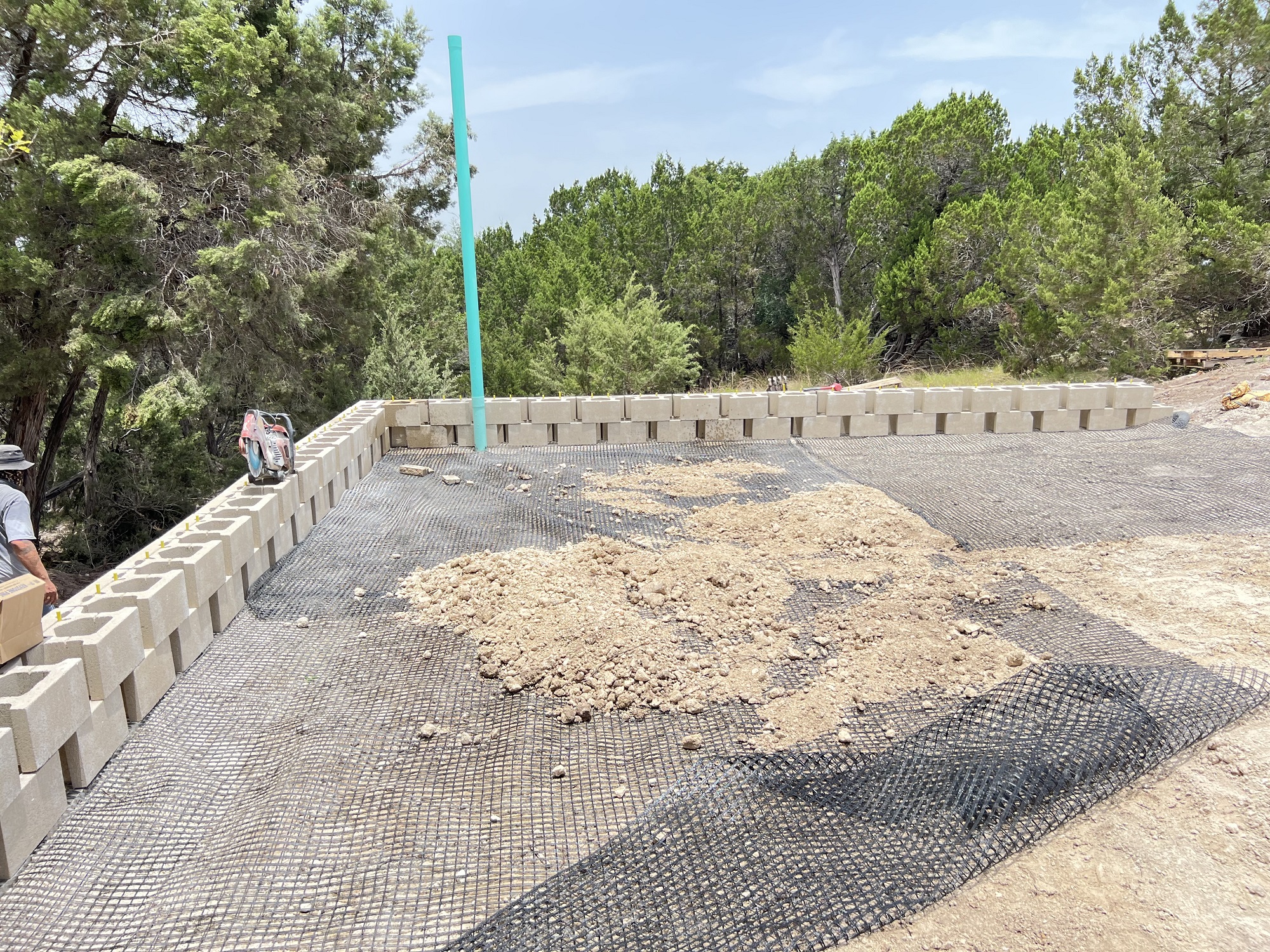 Part of building a strong retaining wall this tall includes adding webbed fabric