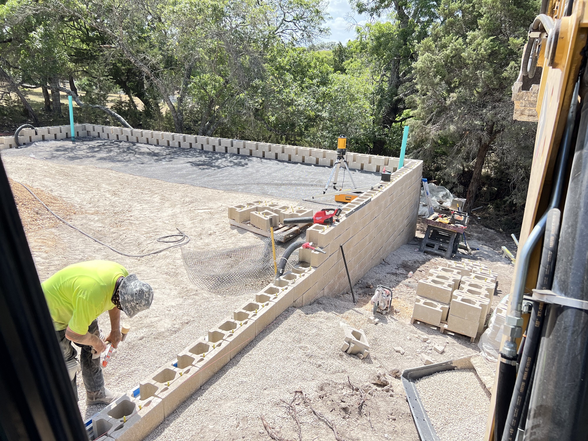 Block retaining wall being built