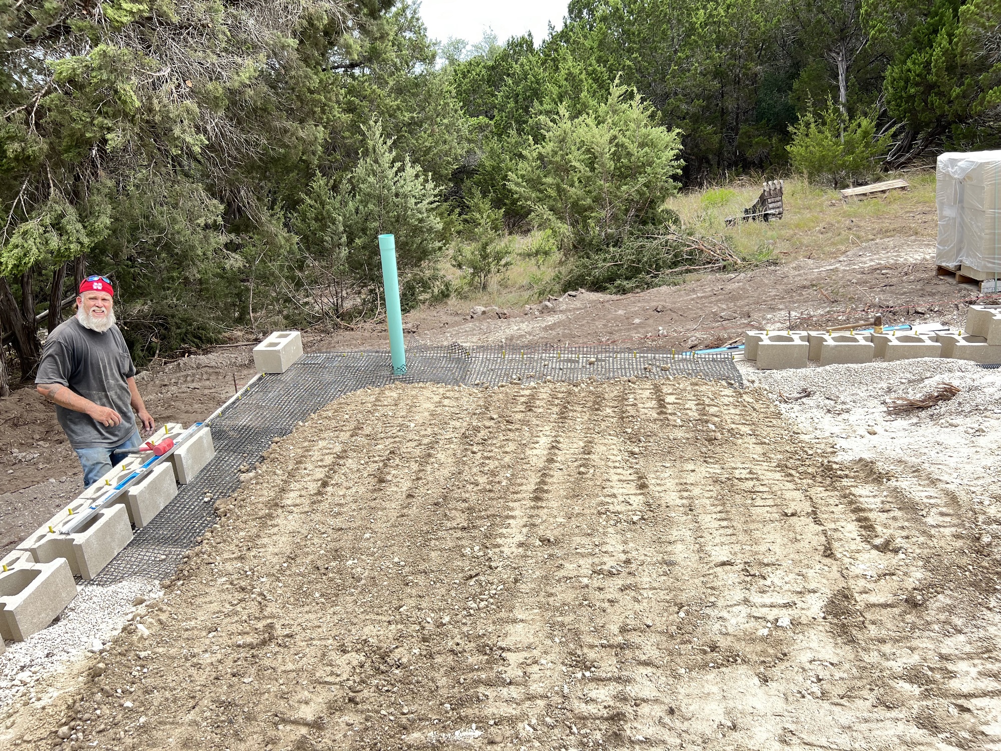 Showing the amount of backfill it takes to hold up a tall block retaining wall