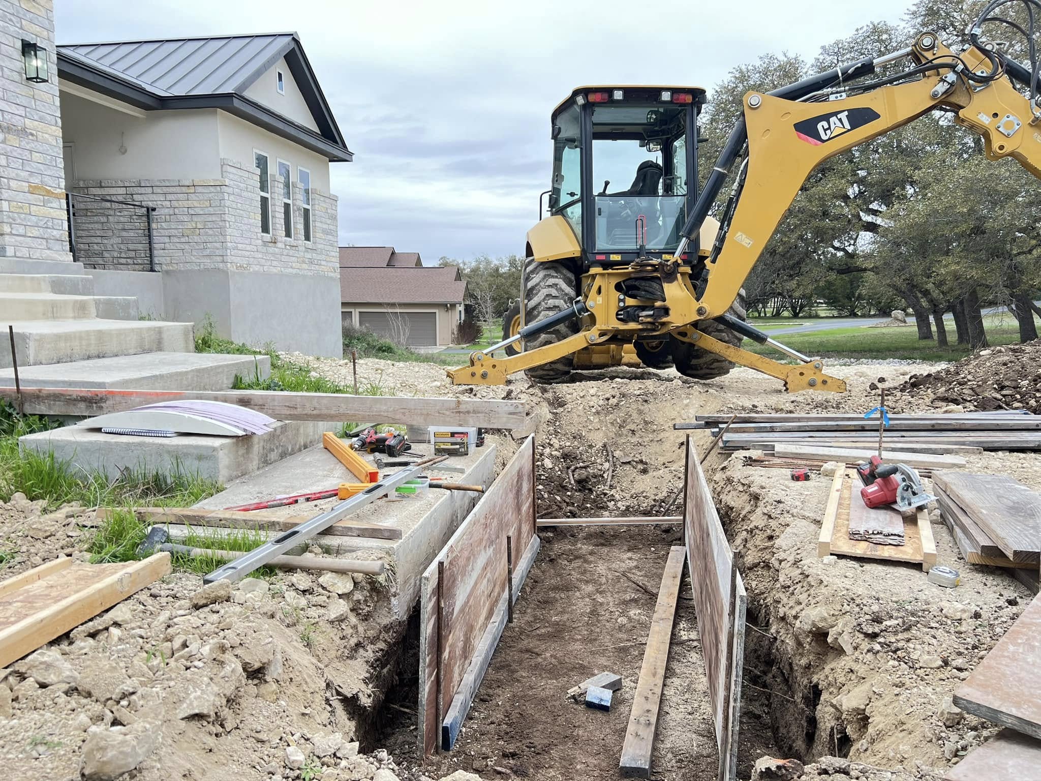 Trench dug for building a bridge in a residential sidwwalk Trench dug for building a bridge in a residential sidwwalk