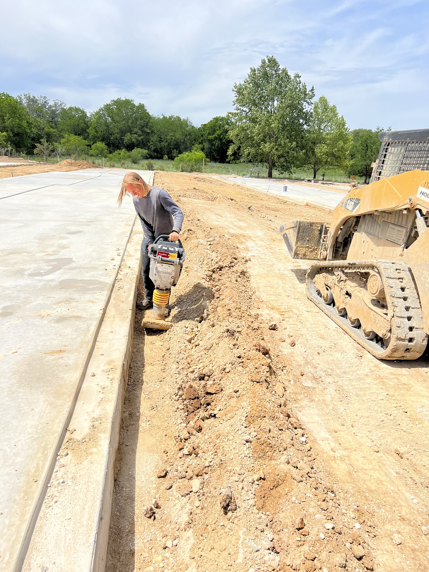 worker using a jumping jack to obtain proper soil compaction
