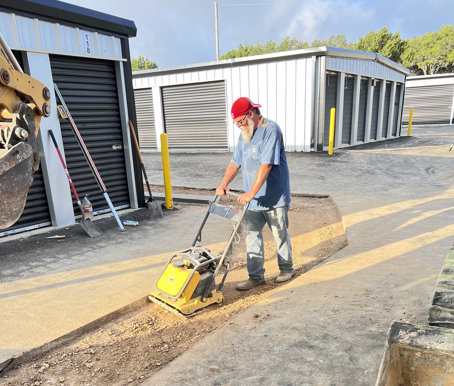 worker using a hand compactor